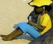 A girl in a yellow hat sitting on a rock with headphones in her ears