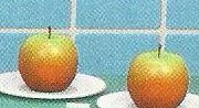 Two red apples on white plates
