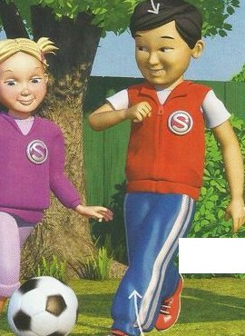 A boy in a red top and blue trousers kicking a football