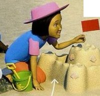 A girl in a pink hat building a sandcastle with a red flag