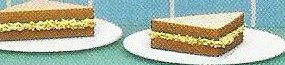 Two cheese sandwiches on white plates