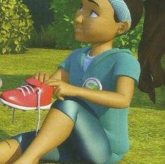 A girl sitting on the grass and putting on a red shoe
