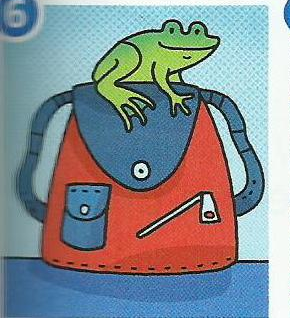 A green frog sitting on a red bag