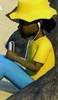 A girl in a yellow hat with headphones, sitting on a rock