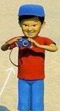 A boy in a blue cap holding a camera