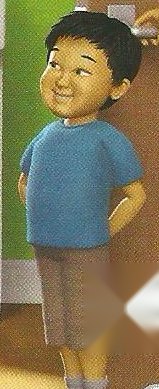 A boy in a blue T-shirt and grey shorts with no cap on his head