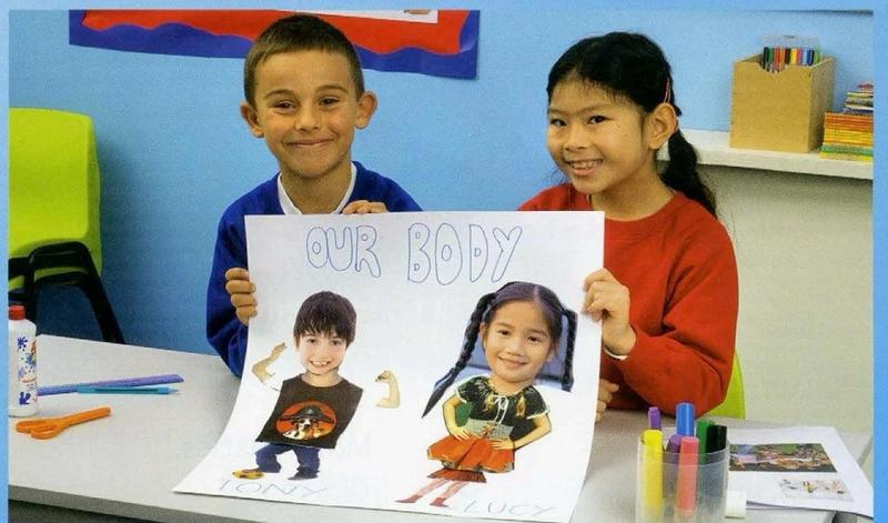 Two children hold a poster called Our body with a boy and a girl on it