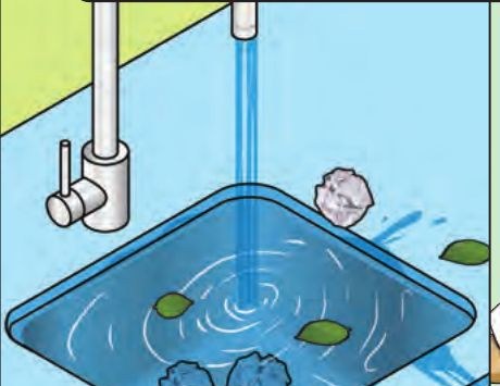 A sink full of leaves and paper, with the tap running
