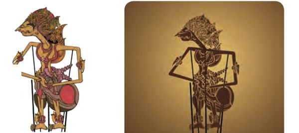 A wayang kulit puppet and its dark shadow on a screen