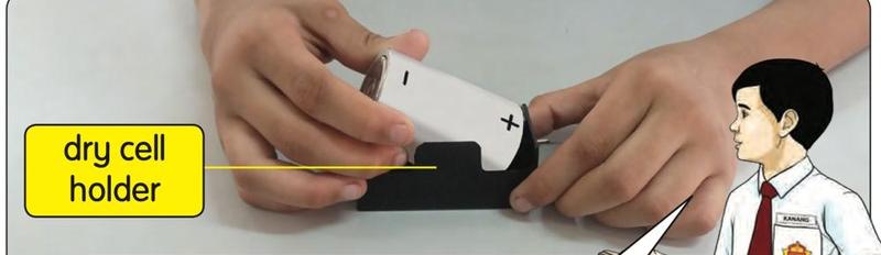 A dry cell being put into a dry cell holder