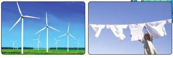 Wind turbines in a field and white clothes drying on a line