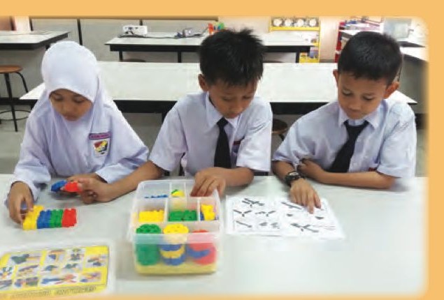Three pupils taking components out of a box