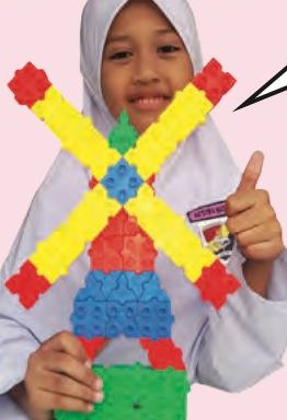 A girl holding a windmill model