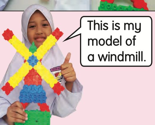 A girl holding up her yellow and red windmill model