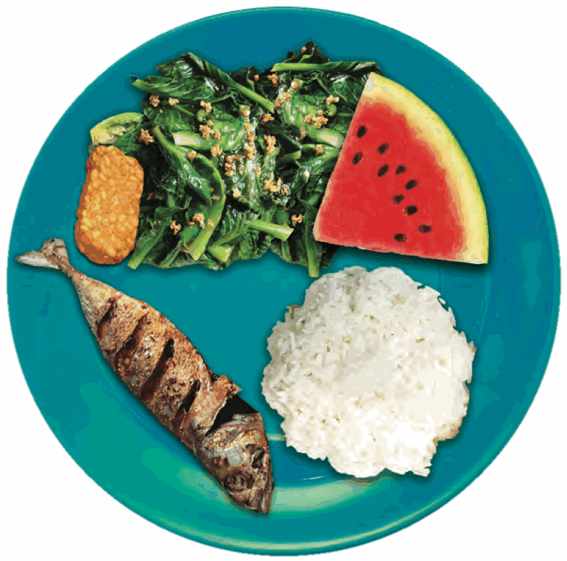 A plate with rice, fried fish, tempeh, green vegetables and a slice of watermelon
