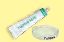 A tube of toothpaste and a dish of toothpaste