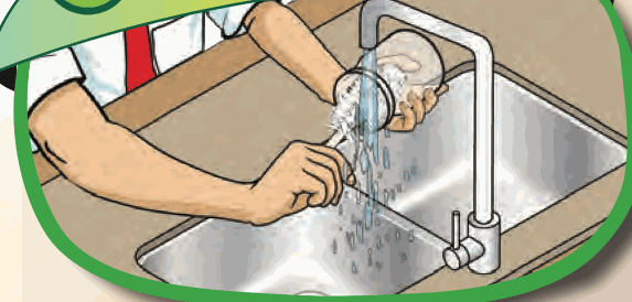 A pupil washing a beaker at the sink
