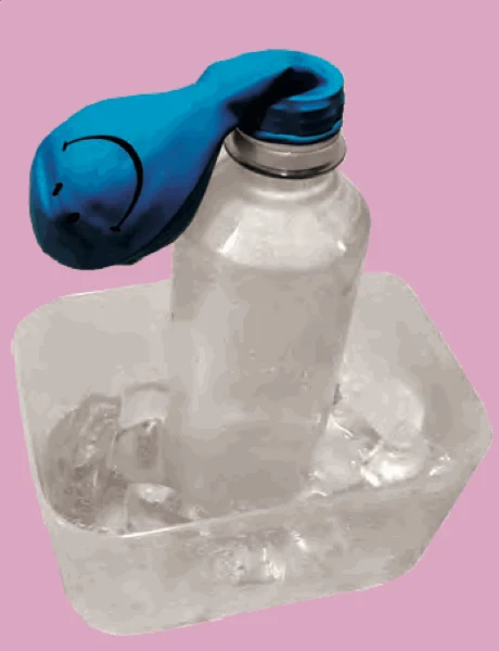 A balloon on a bottle standing in ice cubes