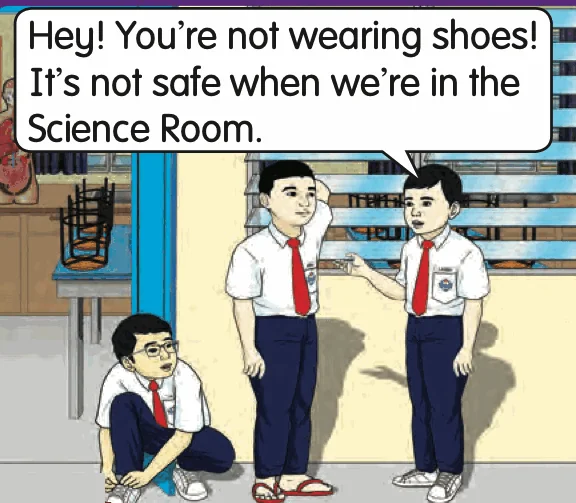 A boy wears slippers in the Science Room; his friend warns him