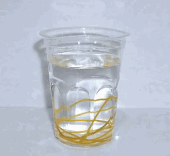 Rubber bands lying at the bottom of a cup of water