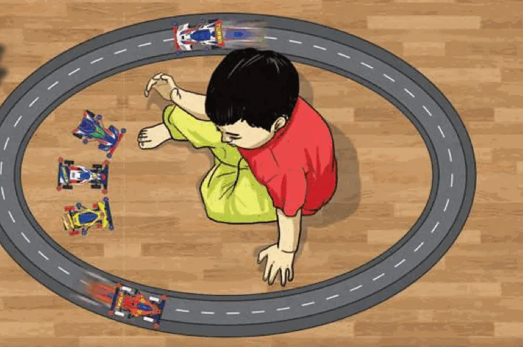 A boy playing with toy cars racing around an oval track