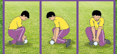 Murid merendahkan badan dan menangkap bola di atas tanah