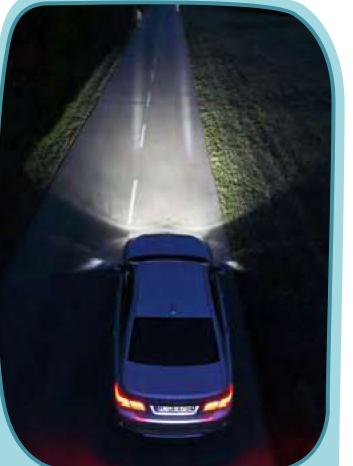 Light beams from the headlights of a car on a dark road