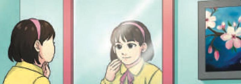 A girl looking at her image in a mirror