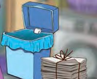 Tong sampah biru yang berpenutup dengan timbunan surat khabar di sebelahnya