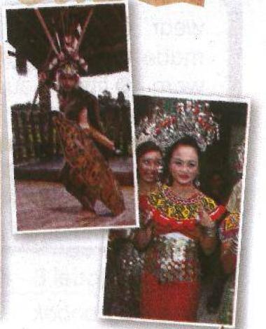 A male Ngajat dancer with a sword and shield, and a female dancer in a beaded headdress and red costume