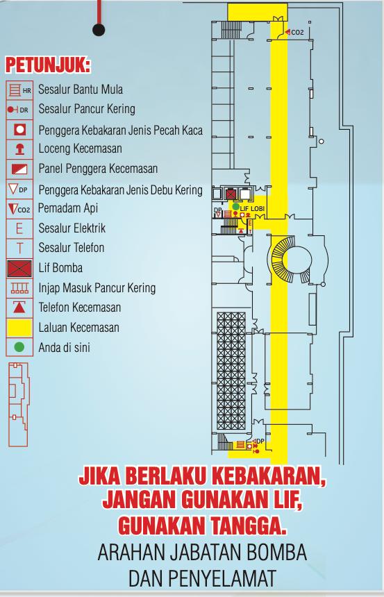 Pelan kecemasan bangunan dengan petunjuk simbol dan laluan kecemasan berwarna kuning