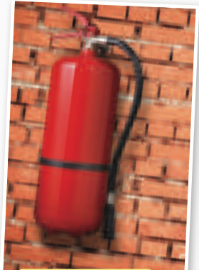 Red fire extinguisher on a brick wall